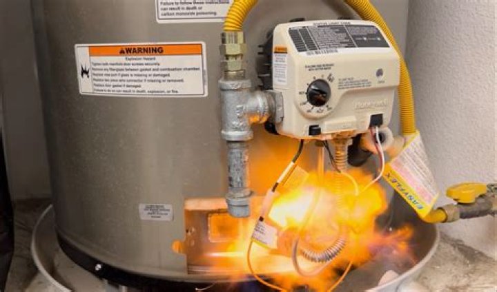How do you check a water heater burner for operation?