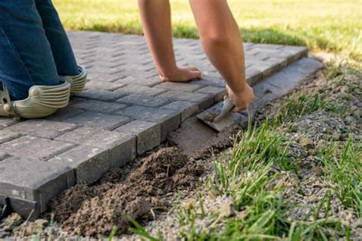 How do you cover a concrete walkway with pavers