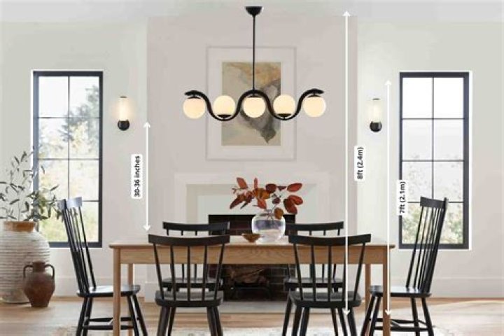 How far from the table should a light fixture hang